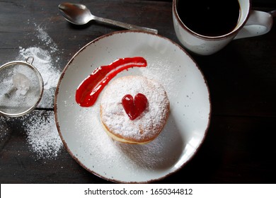 Jelly Filled Donut With Powdered Sugar On A Ceramic Plate. Top View