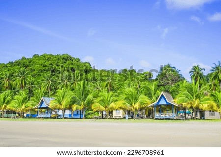 Jemaja Island, Tropical beach with coconut trees, traditional house, and blue sky with clouds on Sunny day. Summer tropical landscape, panoramic view. travel tourism panorama background concept.