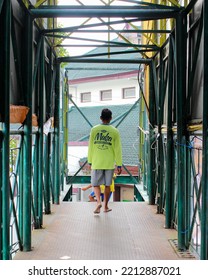 Jember. February 25 2022. An Adult Man Is Walking Leisurely On The Pedestrian Bridge (JPO) In The City Of Jember, With No Shoes On.