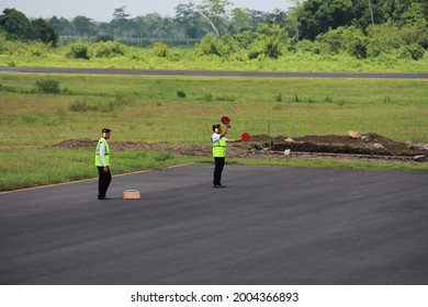 Jember, Indonesia - November 10, 2017: Marshaller (Aviation Marshall) guides pilots to park after landing and enter the parking runway.