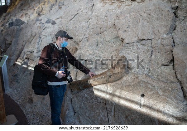 Jensen, CO: October 24, 2021:  Tourists at Quarry\
Exhibit Hall at Dinosaur National Monument..  Dinosaur National\
Monument was established in\
1915.