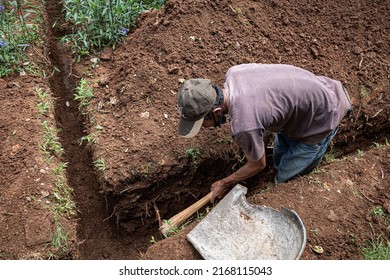 jepara, indonesia, june 16, 2022 a worker digs the ground to repair a water catchment channel
