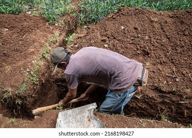 jepara, indonesia, june 16, 2022 a worker digs the ground to repair a water catchment channel