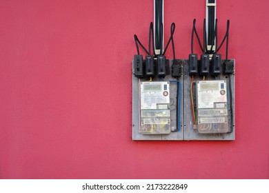 Jerantut, Pahang, Malaysia - 30 June 2022: Digital Electricity Meter On Red Wall