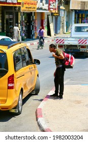 Jericho, Palestine - June 22, 2019
A Man Stared While Talking To The Cab Driver, Near Jericho City, Palestine