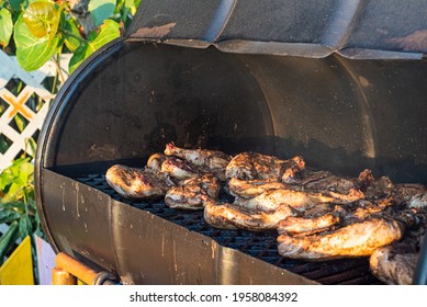 Jerk Chicken Cooked In A Typical Caribbean Style BBQ Made From An Old Oil Drum