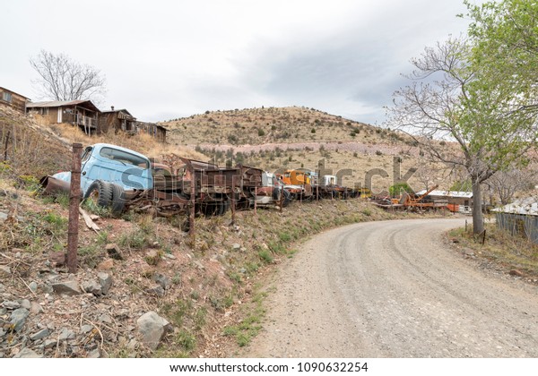 Jerome, AZ, USA - April 16, 2018: road at the\
Gold King Mine & Ghost Town. The town is funky stop with\
dilapidated buildings, an old mine & a large collection of old\
autos & trucks.
