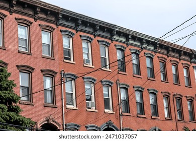 jersey city brownstone building detail (historic pre-war red brick buildings with power lines) beautiful real estate apartment homes with cornice decor urban city life window detail close up family - Powered by Shutterstock