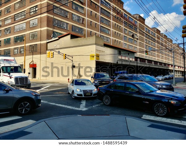 Jersey City, NJ - August 8 2019:\
Cars turning onto Jersey Avenue from 16th Street during rush\
hour
