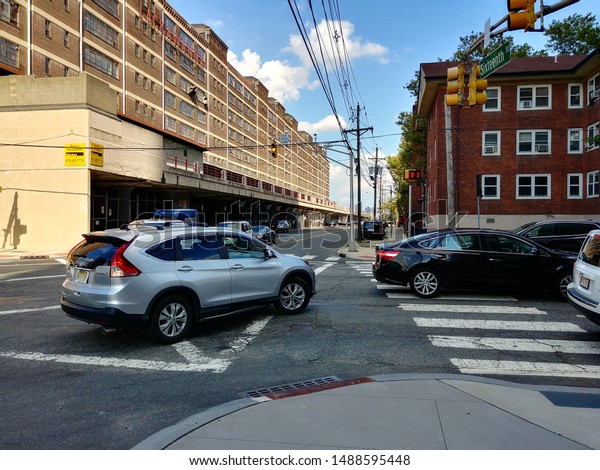 Jersey City, NJ - August 8 2019:\
Cars turning onto Jersey Avenue from 16th Street during rush\
hour