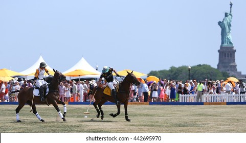 JERSEY CITY, NJ-MAY 30: Rico Mansur (R) handles the ball as Edward Hartman gives chase during a polo match at the Veuve Clicquot Polo Classic at Liberty State Park on May 30, 2015 in Jersey City, NJ.