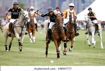 JERSEY CITY, NJ-MAY 31: Hilario Figueras (C) chases the ball during the polo match at the 7th Annual Veuve Cliquot Polo Classic at Liberty State Park on May 31, 2014 in Jersey City, NJ.