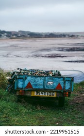 Jersey Island, Channel Island | UK - 2022.01.29: Small Car Trailer Filled With Crab Cages Park At The Seaside