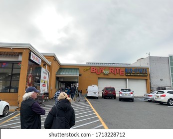 Jersey,City, NJ - April 24 2020: The Buy-Rite Liquor Store During COVID-19 Coronavirus Outbreak With People Waiting Outside For Alcohol