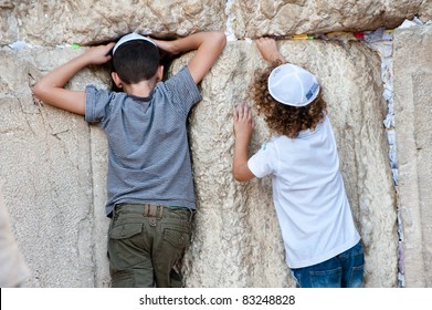JERUSALEM - AUGUST 21: Jewish boys explore the Western Wall, the holiest site in Judaism, in the Old City of Jerusalem on Aug. 21, 2011.