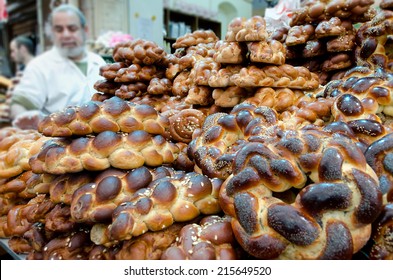 JERUSALEM - DEC 30 2011: Jewish man buying Challah bread for Shabbat Jewish Holiday at Mahane Yehuda Market in Jerusalem Israel.