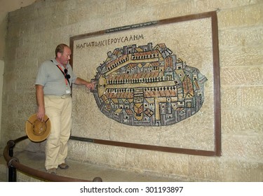 JERUSALEM, ISRAEL - 09 OCTOBER, 2012: The Guide Shows The Ancient Byzantine Mosaic Map Of Ancient Jerusalem