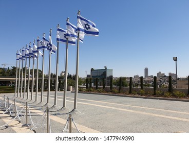 JERUSALEM, ISRAEL. August 13, 2019. A row of flags of Israel in front of the Israeli parliament Knesset. Israeli flags against the sky. Israel Independence Day concept.