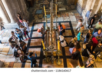 Jerusalem, Israel, August 20th, 2018: Tourists and pilgrims are playing Stone of Anointing, the spot where Jesus' body was prepared for burial by Joseph of Arimathea, in Church of the Holy Sepulcher