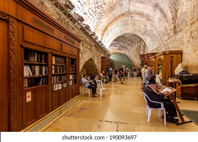 JERUSALEM, ISRAEL - AUGUST 21, 2013: Prayers and visitors inside of Cave Synagogue which is a part of Western Wall (aka Wailing Wall) - Judaism's holy place located in Jerusalem, Israel.