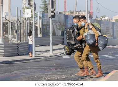 Jerusalem, Israel - August 6th, 2020: Two Israeli Soldiers, Carrying A Lot Of Gear And Wearing COVID Masks On A Jerusalem, Israel Street.