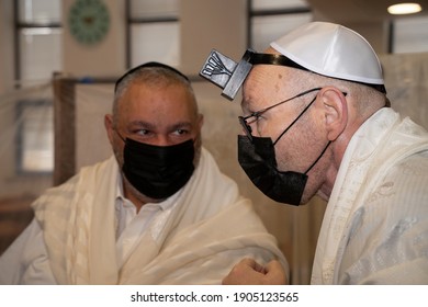 Jerusalem, Israel - January 28th, 2020:People Praying In A Synagogue, Wearing Protective Masks.