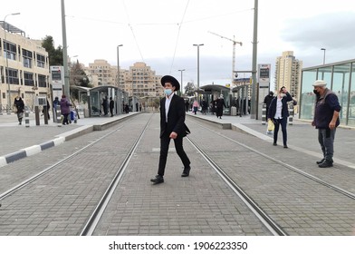 Jerusalem \ Israel - January 31 2021: Young Orthodox Jew Wearing Medical Protective Mask Crosses The Railway Near Jerusalem Central Bus Station. 