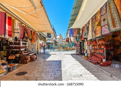 JERUSALEM, ISRAEL - JULY 10, 2014: Bazaar in Old City of Jerusalem offers middle east traditional products and souvenirs. It is very popular with locals, tourists and pilgrims visiting Israel.