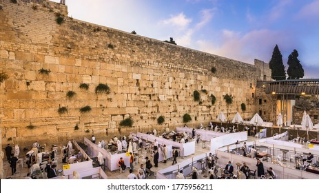 Jerusalem, Israel - July 12 2020: Orthodox Jews praying at the Western Wall during coronavirus; barriers separate the plaza into sections because of COVID-19 pandemic regulations