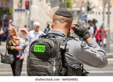 JERUSALEM, ISRAEL. June 20, 2017. Israel Border Police Guard Fixing Earphone By The Damascus Gate, The Place Of The Recent Terror Attack. Israeli Police Soldier Security Stock Image.