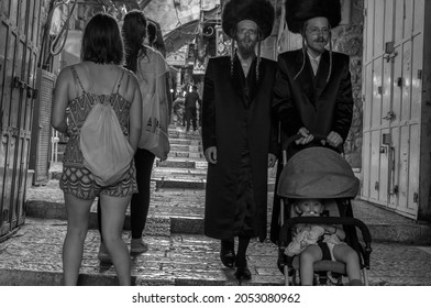 Jerusalem, Israel - June 2019: Orthodox Jewish family in traditional clothing on the street of the old city of Jerusalem. An Ultra Orthodox religious Jewish family in Sabbath day