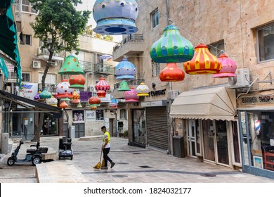 Jerusalem, Israel - September 16th, 2020: A Decorated Street, Empty Due To COVID Pandemic, But For A Protective Mask Wearing Street Cleaner.