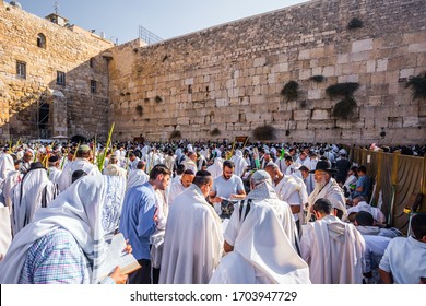 JERUSALEM, ISRAEL - SEPTEMBER 26, 2018: Jews praying wrapped in festive white Talit. Touching ceremony at the Western Wall. The blessing of the Cohanim. The concept of pilgrimage and photo tourism