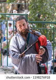 Jerusalem, Israel, September 29, 2018 : Participant of the festival in the traditional medieval dress plays music on the bagpipes at the annual festival `Jerusalem Knights`