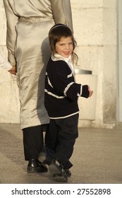 JERUSALEM - MAY 22 : Young Orthodox Jew Follows His Father Through Old Town Jerusalem May 22, 2007 In Jerusalem, Israel.