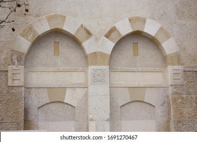 Jerusalem / Palestine - February 18th 2014:  of King Hussain Bin Talal Mosque in Amman, Jordan. Stunning white stoned prayer hall and courtyard with arched pillars.