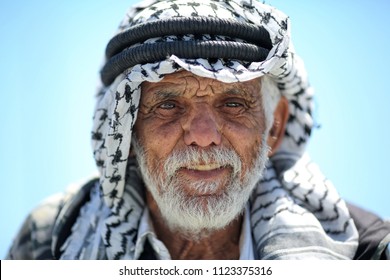 Jerusalem ,Palestine - March 18, 2018: Palestinian old man wearing Keffiyeh with a white beard and a blue background