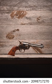 Jesse James gun against old wood backdrop