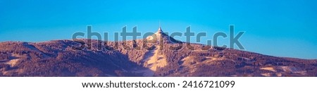 Jested Mountain with unique hotel and TV transmitter on the top on sunny winter day, Liberec, Czechia