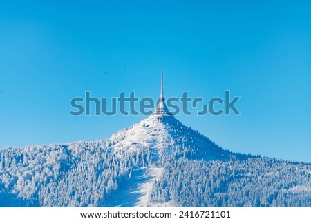 Jested Mountain with unique hotel and TV transmitter on the top on sunny winter day, Liberec, Czechia