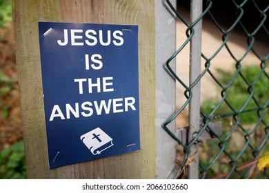 Jesus Is The Answer Sign, Stapled To Wooden Post Beside Chain Link Fence