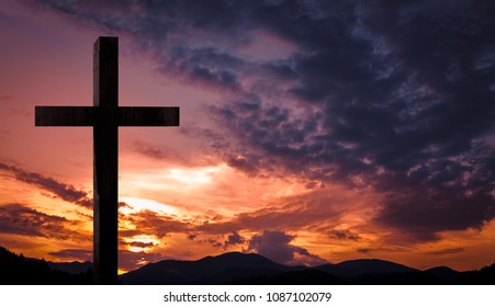 Jesus Christ cross, wooden crucifix. Crucifixion concept on a heavenly background with dramatic light and clouds and colorful orange, purple sky at sunset. Religious Easter, resurrection concept - Shutterstock ID 1087102079
