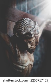 Jesus Christ crucified. Dramatic image of an ancient wooden statue.  - Shutterstock ID 2255717455