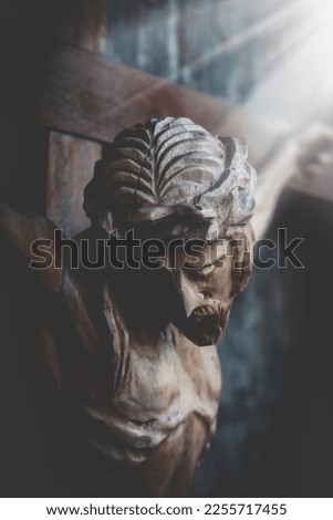 Jesus Christ crucified. Dramatic image of an ancient wooden statue. 