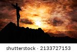 Jesus Christ crucified on the cross at Calvary hill with burning sky in background