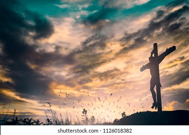 Jesus christ crucified on cross on calvary sunset background concept for good friday he is risen redemption in easter sunday, death on crucifix, christian mission service in church and holy spirit.