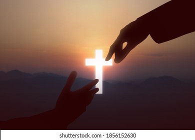 Jesus Christ Giving A Helping Hand To Human With A Sunset Sky Background