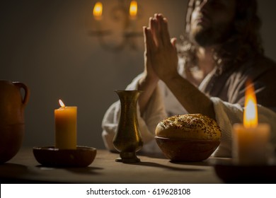 Jesus christ holding prayer to god father at his last supper - Shutterstock ID 619628108