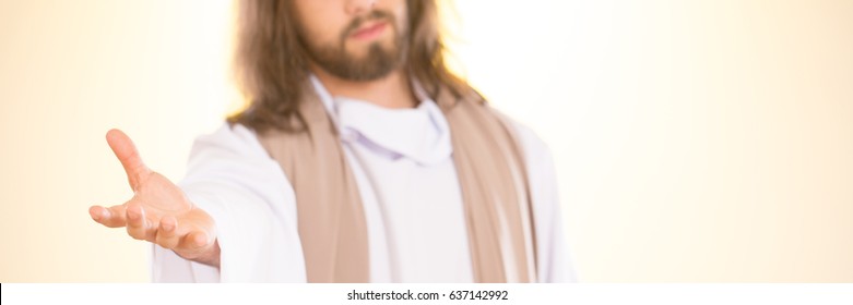 Jesus Christ reaching out his hand against bright background