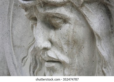 Jesus Christ statue against a background of gray stone 